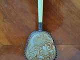a spoon that is sitting on a wooden table