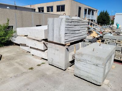a pile of concrete blocks in front of a building