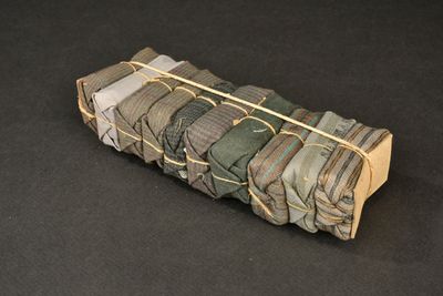 a roll of cloth wrapped in gold wire on a black surface