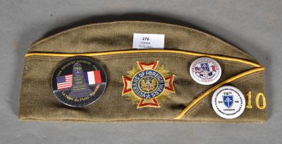 an image of a hat with badges on it sitting on a table