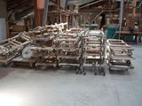 many pieces of wood on the floor in the warehouse