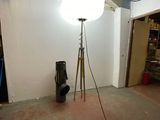 a lamp that is on a tripod in a room