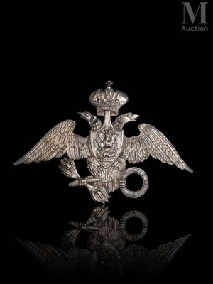 a close up of a metal bird with a crown on it ' s head