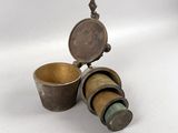 two cups and a spoon sitting next to each other