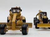 two toy construction vehicles that are sitting side by side