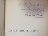an open book with a handwritten title on it sitting on top of a table