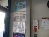 a clock on the wall next to a wall with a bunch of information