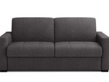 a gray couch sitting on top of a white floor next to a white wall