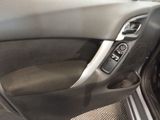 the interior of a car with the door open and the door handle open