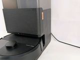 an image of a robotic vacuum cleaner on top of a box
