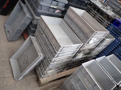 a pile of crates sitting on a pallet in a warehouse