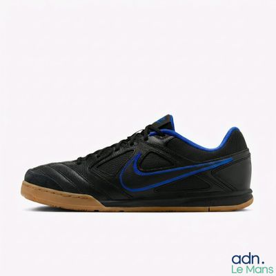 un gros plan d'une chaussure noire et bleue sur fond blanc