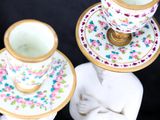 two cups and saucers sitting on top of each other