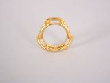 a close up of a gold ring on a white surface