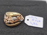 a gold ring with stones in it and a price tag