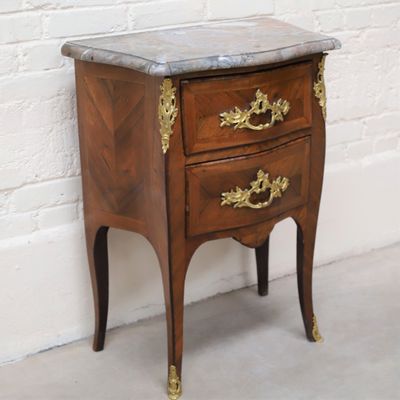 a small wooden table with a marble top on it