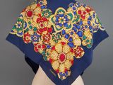 an image of a blue scarf with gold and red flowers on it