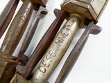 two old tools that are sitting on a white surface