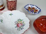 a white table topped with a bowl and a plate