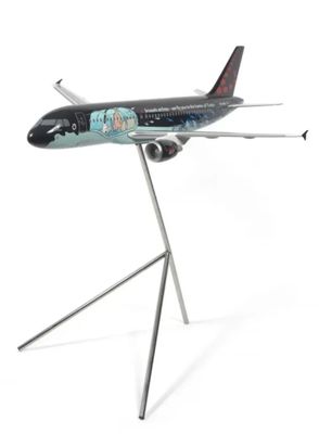 a model of an airplane on a stand on a white surface