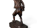 bronze statue of a man with a hat on his head