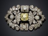 a yellow diamond and diamond broochle
