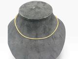 a close up of a necklace with a gold chain on it