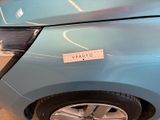 a blue car with a sticker on the side of it