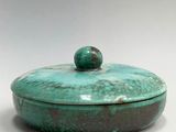 turquoise green ceramic covered dish with lid on a white surface
