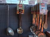 many utensils hanging on the wall in the store