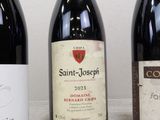 three bottles of wine are lined up on a table