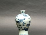 a blue and white vase sitting on a table