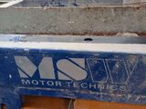 an image of a machine that is working on a piece of metal