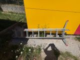 a man that is standing next to a yellow wall