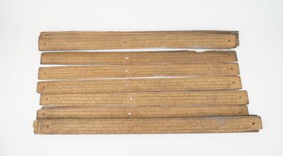 six pieces of wood are arranged on a white surface
