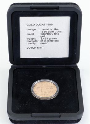 an image of a gold coin in a black case on a white background