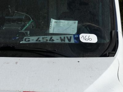 a white car with a sticker on the front window