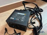 a computer power supply sitting on a wooden table