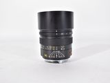a close up of a camera lens on a white surface