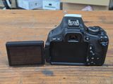 a camera that is sitting on a table next to a small device
