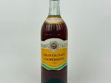 bottle of honey syrup on a white surface with a white background