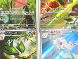 four pokemon cards are displayed on a table in a room