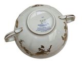 a white bowl with a gold design on it