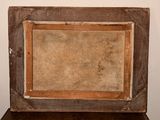 an old picture frame sitting on top of a wooden table