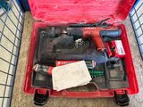 a red tool box with tools in it on the floor