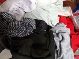 a pile of clothes that is sitting on the floor