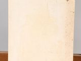 an old photo of a piece of paper on a wooden easel