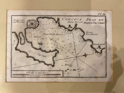 an old map on display in a glass case with a shadow of a person