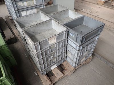 a stack of crates sitting on a pallet in a warehouse