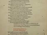 an old book with a black and red writing on it